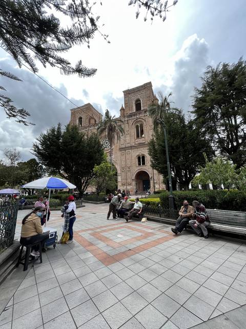       Building with people sitting and relaxing around.
  