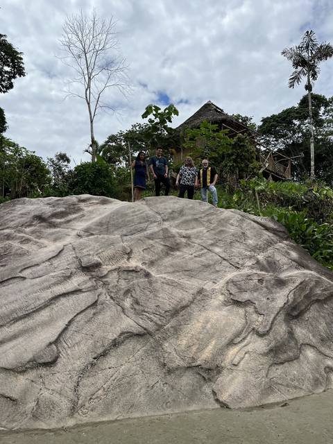       Group of people standing on a rocky landscape.
  