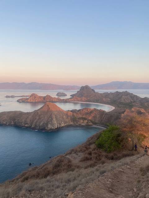       Landscape featuring a winding coastal path with hills
  