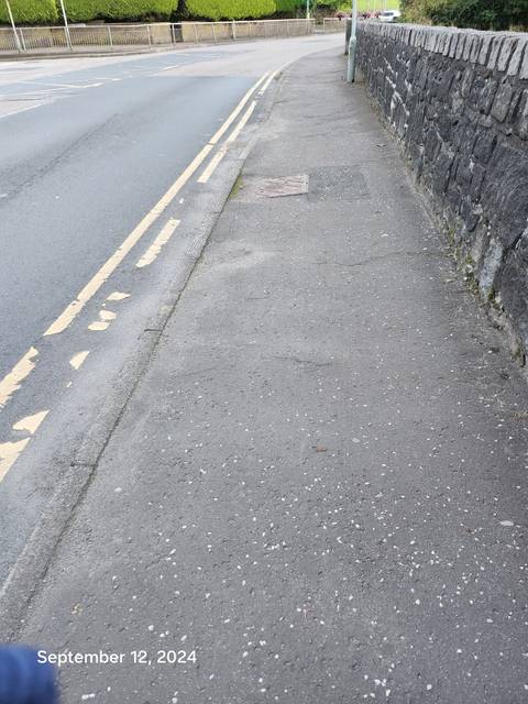       Sidewalk and street view of urban area.
  