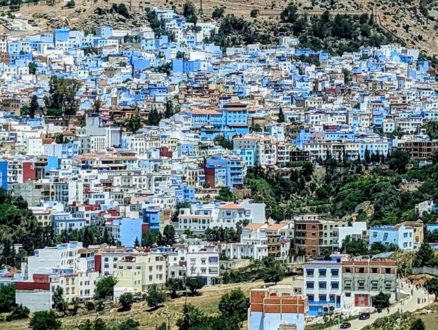       Couple sitting in a traditional Moroccan lounge with decorative tables.
  