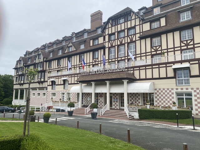 Large hotel with flags and a checkered facade.