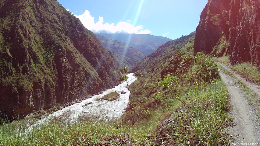Ravine with a river and road on the side.