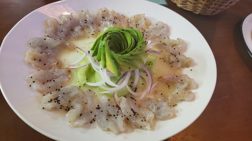       Appetizing dish of shrimp and avocado arranged artistically.
  