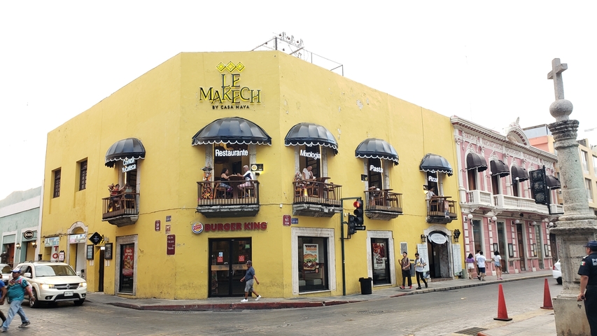 Yellow building with traditional architecture and signage in Spanish.