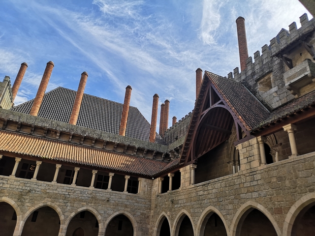 Historical building with distinctive chimneys and architectural features.