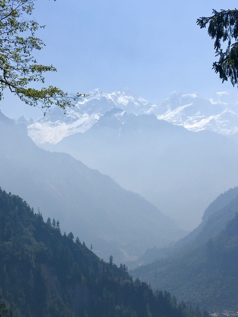       Hazy mountains with snow-capped peaks.
  