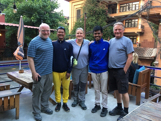 Group of people posing together in a gathering area.