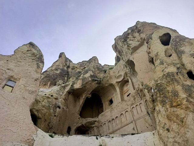 Rock-cut architecture against a blue sky.