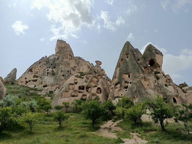       Rocky hillside with ancient dwellings.
  