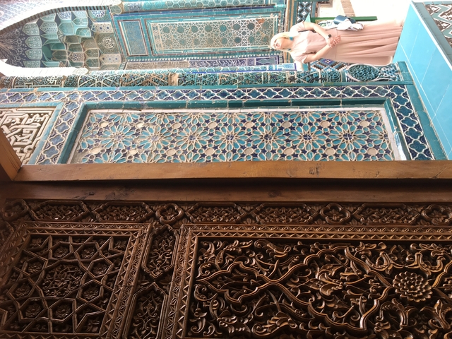 Intricately carved wooden and tiled details, possibly part of an architectural structure.