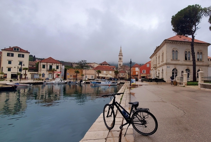 Charming seaside town with buildings and boats.