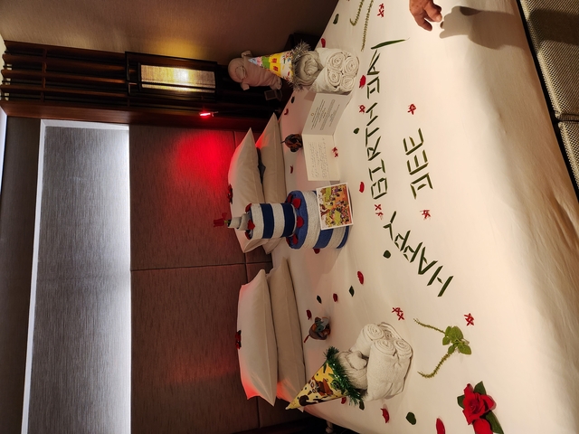 Hotel room bed decorated for a birthday celebration.