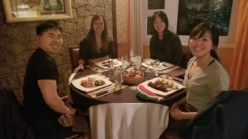 Friends having dinner at a cozy restaurant.