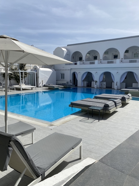      Luxurious pool and lounge area at a resort.
  