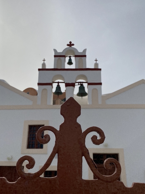       White church with bells and architectural details.
  