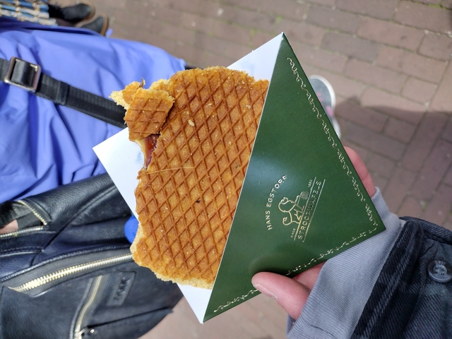       Stroopwafel in packaging held by a person.
  