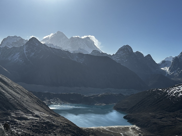 Mountainous landscape with snow-capped peaks and a lake