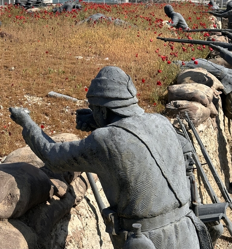       A stone statue of a soldier in a historical setting.
  