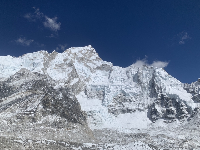 Snow-covered mountain peaks under a clear blue sky.