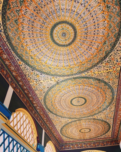 Intricate ceiling art with colorful patterns.