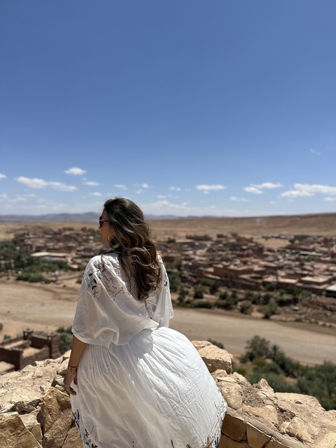 Woman overlooking a view of a Moroccan town.