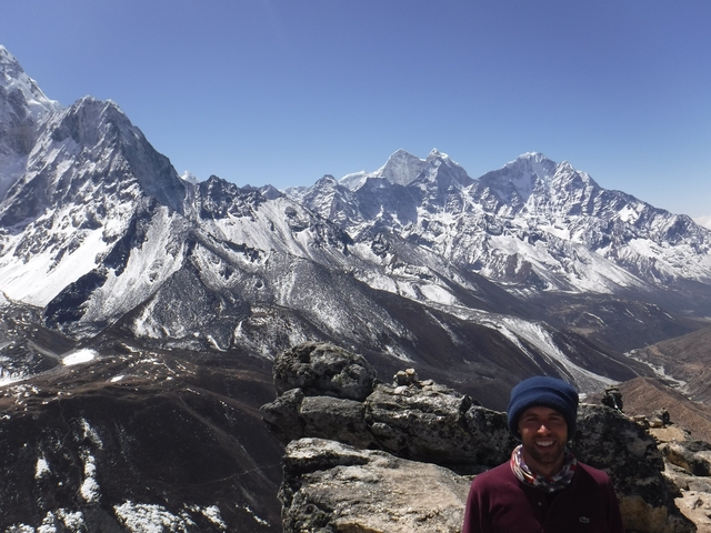 Snowy mountain peaks with a person partially visible at the bottom.