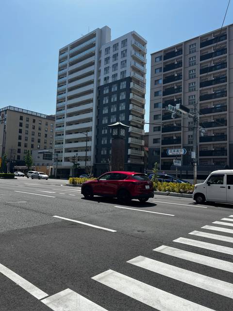       Street with a mix of modern and traditional buildings.
  