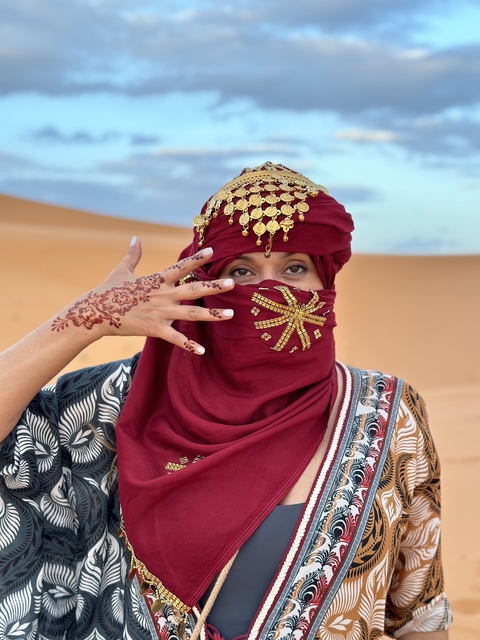 Person in traditional Moroccan attire in the desert