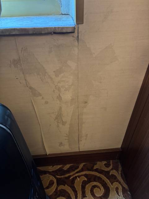 Upside-down view of a damaged hotel wall.