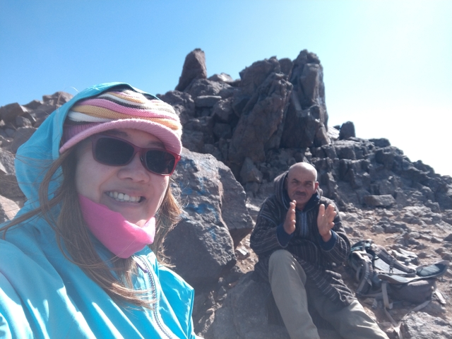 Two people resting on a rocky mountain