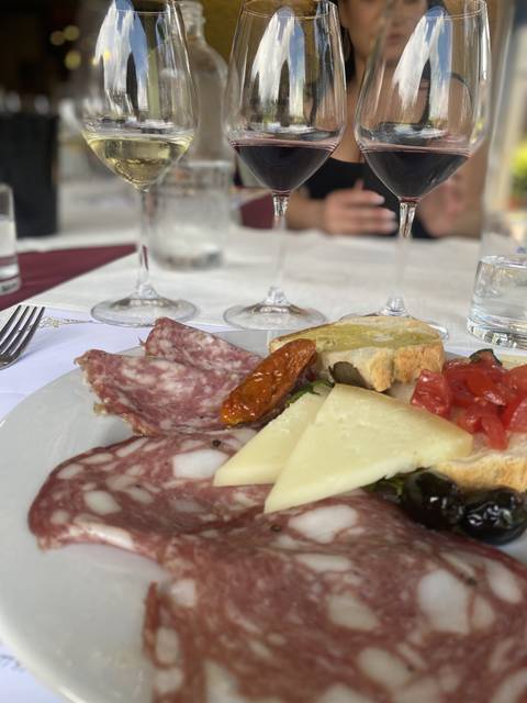 Close-up of a plate with cheese, meats, and bread.