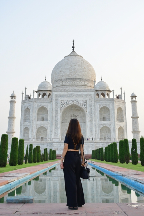       A person standing in front of the Taj Mahal
  