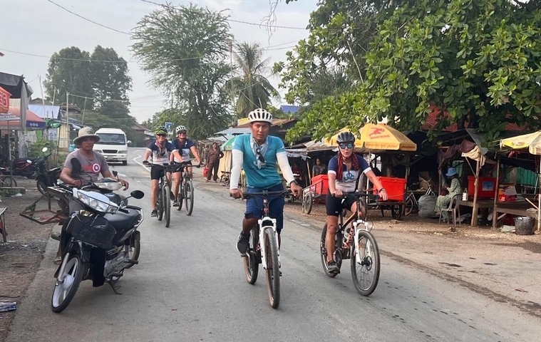 Cyclists riding down a rural road