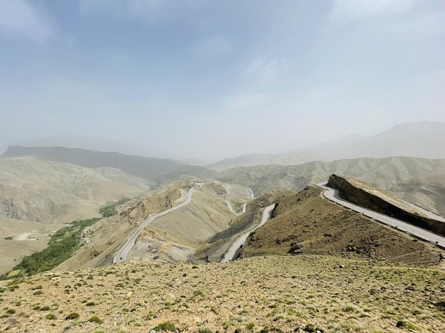       Winding desert roads in a mountainous landscape.
  