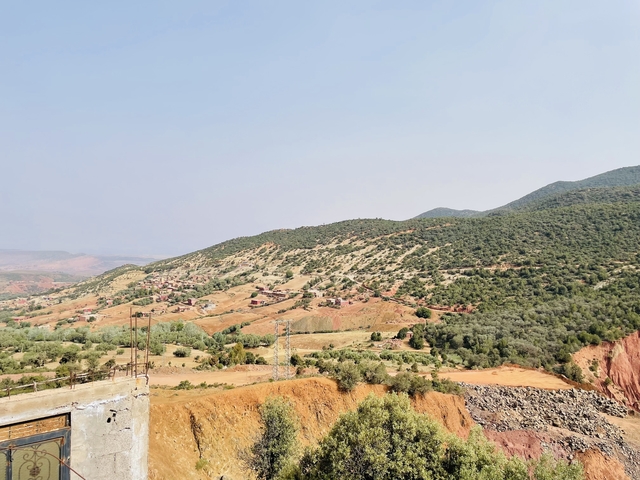       Expansive view of rolling hills and valleys under a clear sky.
  