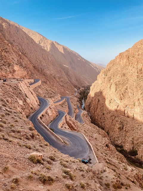 Winding road through Todra Gorge with steep cliffs.