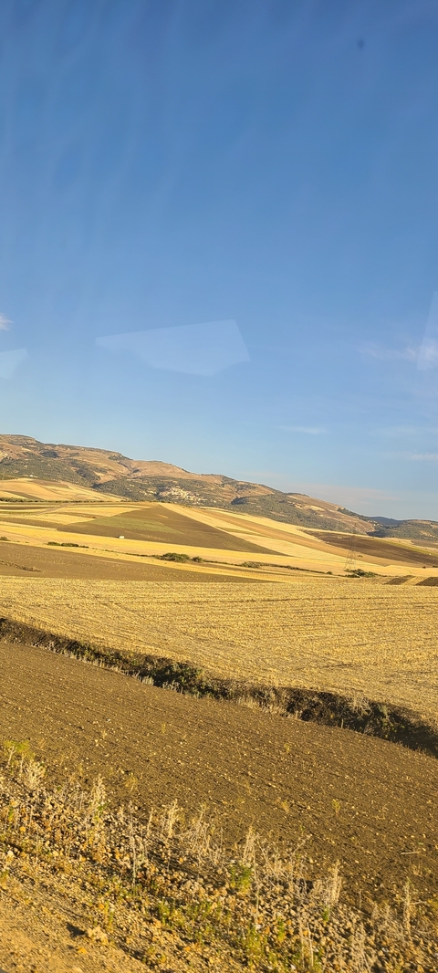       Vast landscape of fields and hills in rural Spain.
  