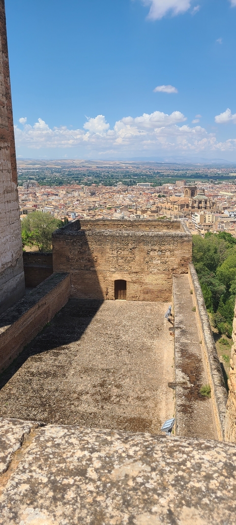      View of city rooftops with historical architecture.
  