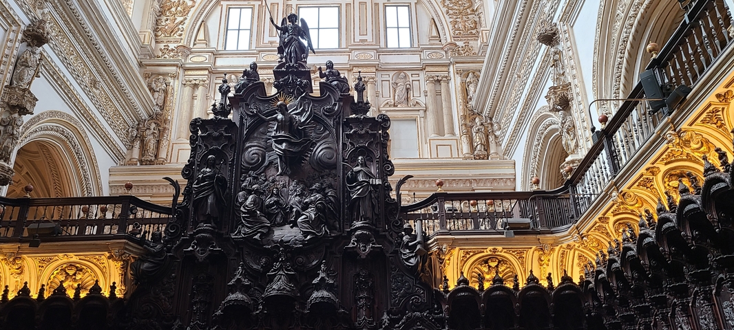       Intricate interior of a cathedral with detailed wood carvings.
  