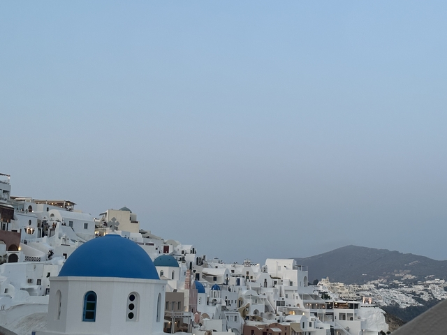 Scenic view of Santorini with blue-domed churches and white buildings.