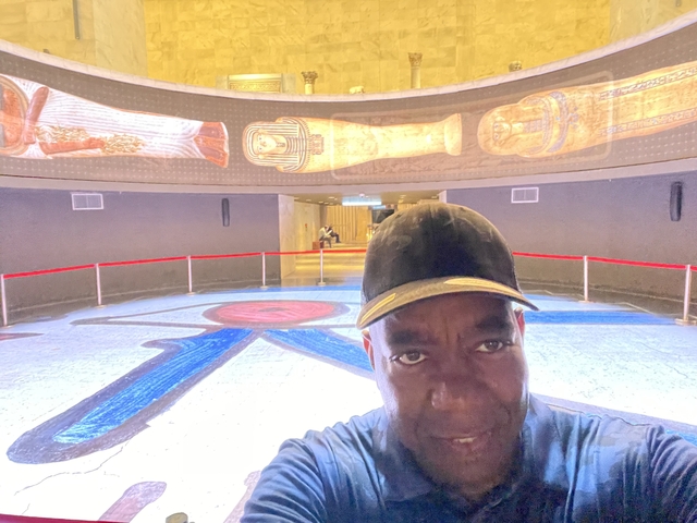       Person with bright murals in a modern interior.
  