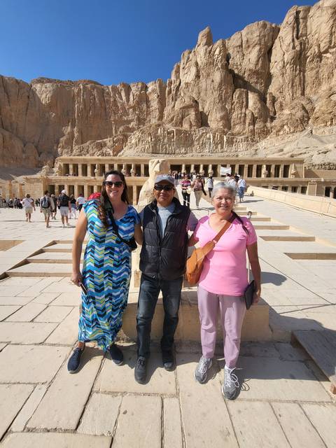 Three people posing in front of ancient Egyptian structures.