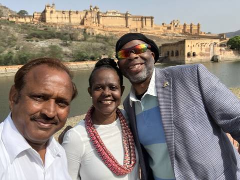 Selfie of a group with a historical structure in the background.