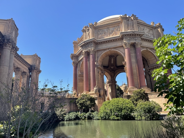 Classical architectural structure surrounded by greenery.