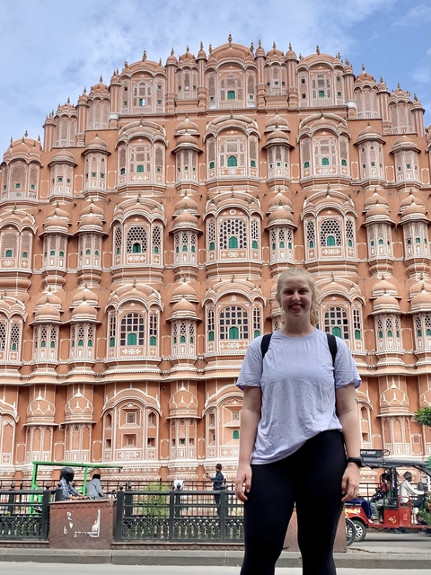 Person standing in front of Hawa Mahal, Jaipur, India.