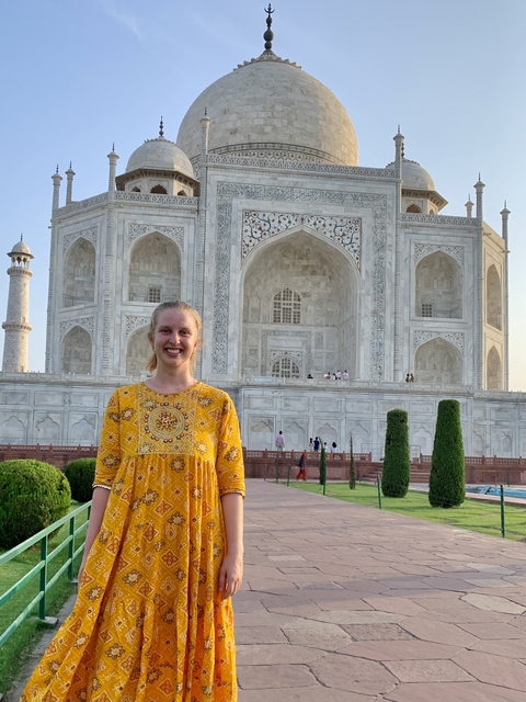 Person standing in front of the Taj Mahal, a famous landmark in Agra, India.