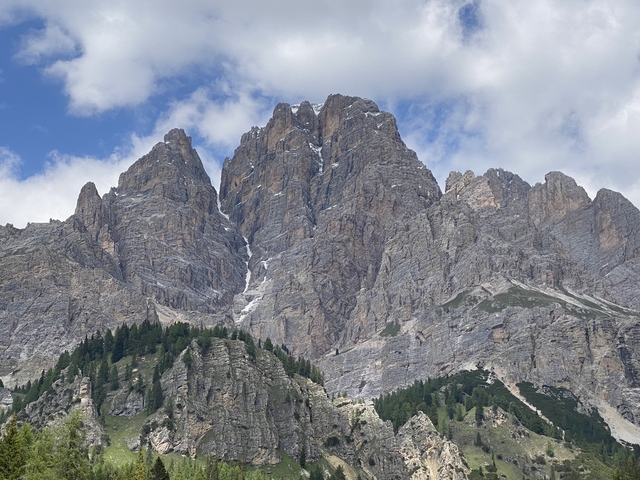 Rocky mountain peaks under a partly cloudy sky.