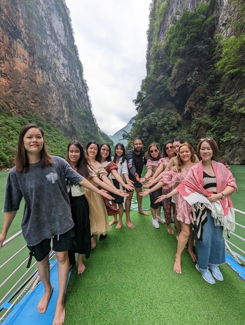       Group of people posing in a scenic valley.
  