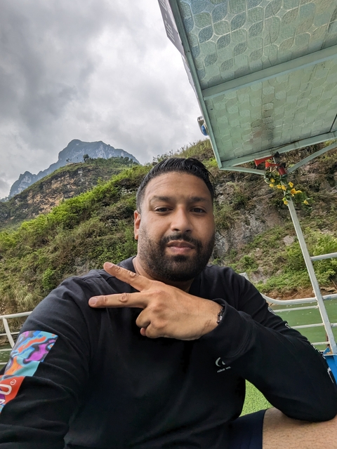       Person posing with mountains in the background.
  